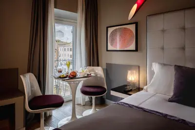 a bedroom with a king sized bed and a living room at Maison Torre Argentina in Rome