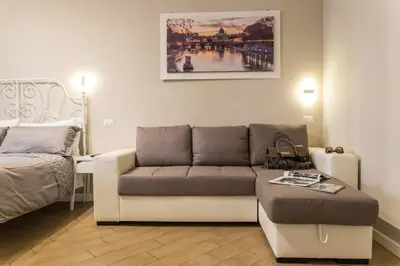 a living room with a couch and a bed at Residenza Romana Vaticana in Rome