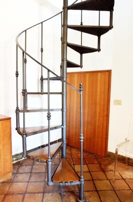 a metal spiral staircase in a room with a door at Domus Rotundae Pantheon in Rome
