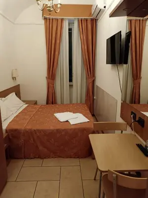 a hotel room with a bed and a desk and a television at Appartamento Privato Simone in Rome