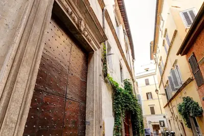 a large wooden door on the side of a building at Navona Charming Flat in Rome