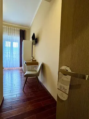 a room with a door with a chair and a mirror at La Muraglia Di San Pietro in Rome
