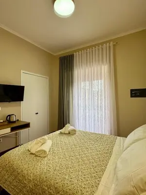 a bedroom with a bed with two towels on it at La Muraglia Di San Pietro in Rome