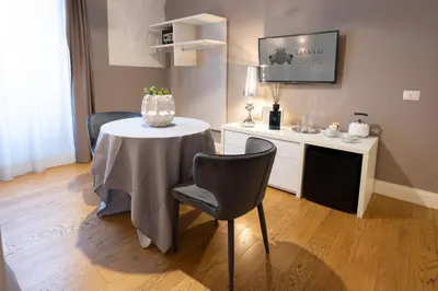 a room with a table with a vase on it at Cardilli Luxury Rooms in Rome
