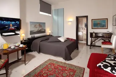 a bedroom with a bed and a piano in a room at Roma Central Guest House in Rome