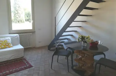 a living room with a staircase and a table and chairs at Foro Romano Palatino View Relais in Rome