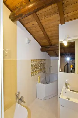 a bathroom with a tub and a toilet and a sink at Foro Romano Palatino View Relais in Rome