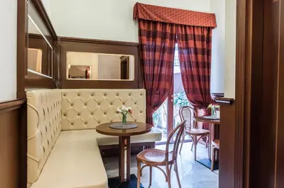 a living room with a table and chairs and a couch at Domus Augusta in Rome