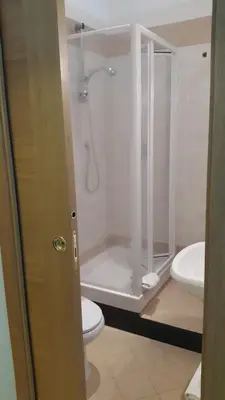 a bathroom with a shower and a toilet and a sink at Domus Augusta in Rome