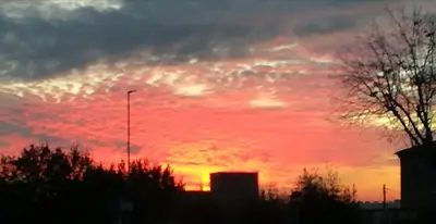 a sunset with a red sky with clouds at Roma Metro Furio Camillo in Rome