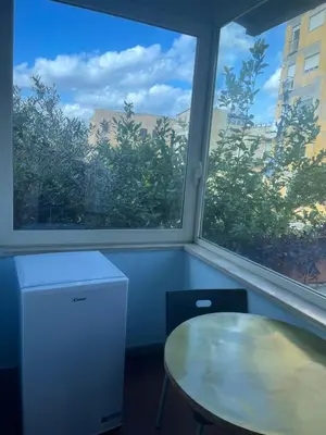 a room with a table and two large windows at Residence Lodi in Rome