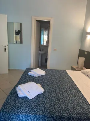 a hotel room with two towels on a bed at Residence Lodi in Rome