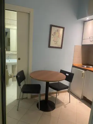 a kitchen with a table and chairs in a room at Residence Lodi in Rome