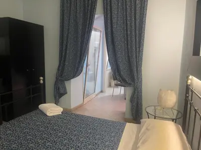a bedroom with a bed and a window with curtains at Residence Lodi in Rome