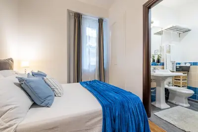 a bedroom with a bed and a sink and a mirror at Suite 36 in Rome