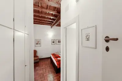a hallway with a room with a bed and a door at Domus Quiritum Charming, Appartamento d'Epoca a Campo de' Fiori in Rome