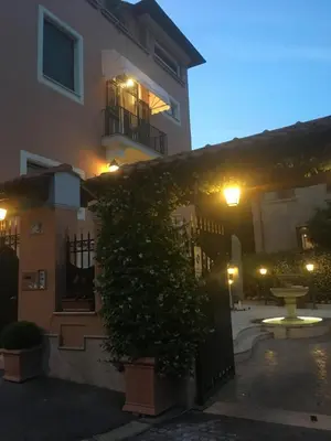 a building with a gate with a bush in front of it at B&B VILLINO MARGHERITA in Rome