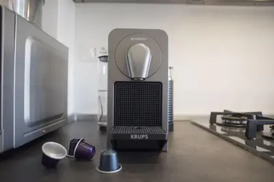 a mixer sitting on a table next to a tv at Suite GG in Vatican in Rome