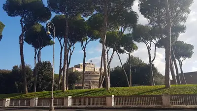 a park with a building in the background with trees at CIVICO 7 Holiday Rooms in Rome
