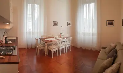 a kitchen and dining room with a table and chairs at St Paul House Boutique & Apartment in Rome