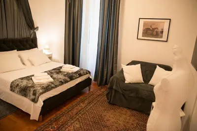 a hotel room with a bed and a couch at St Paul House Boutique & Apartment in Rome