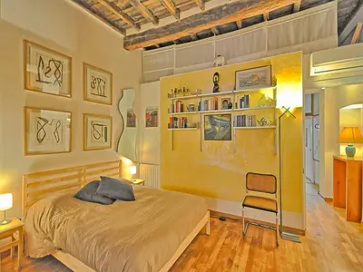a bedroom with a bed and a chair in it at Terrace Governo Vecchio in Rome