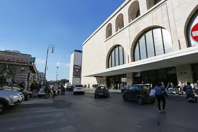 a busy city street with cars parked in front of a building at Hotel Chicago in Rome