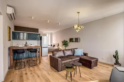 a living room with a couch and a kitchen at Sant'eiligio loft campo di fiori in Rome