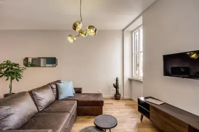 a living room with a couch and a tv at Sant'eiligio loft campo di fiori in Rome