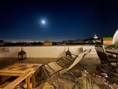 a couple of chairs and a table on a roof at Penthouseinrome in Rome