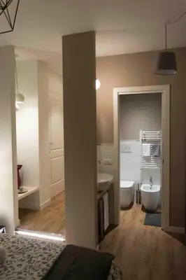 a bathroom with a tub and a sink and a toilet at St. Peter's Luxury Rooms in Rome