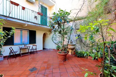 a courtyard with plants and a table and chairs at Characteristic apartment just beside the Vatican in Rome