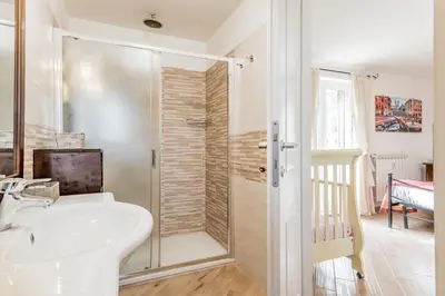 a bathroom with a white sink and a shower at Il Nido di Lulu in Rome