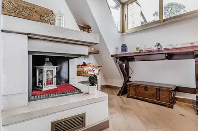 a living room with a fireplace and a window at Il Nido di Lulu in Rome
