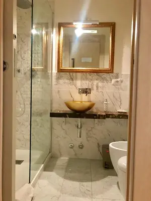 a bathroom with a sink and a mirror and a shower at Biancalunagiulia in Rome