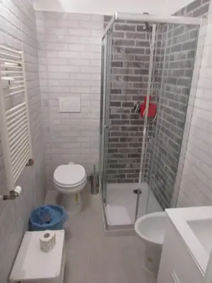 a bathroom with a shower and a toilet and a sink at PIANETA ROMA 39 in Rome