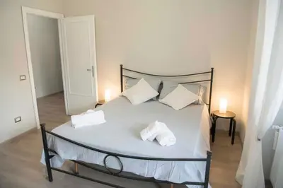 a bedroom with a bed with two pillows on it at Green view apartment in Rome