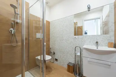 a bathroom with a shower and a toilet and a sink at St. Paul Palace Relais in Rome