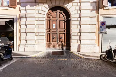 a door to a building with motorcycles parked in front of it at Luxurious loft facing the Pantheon in Rome