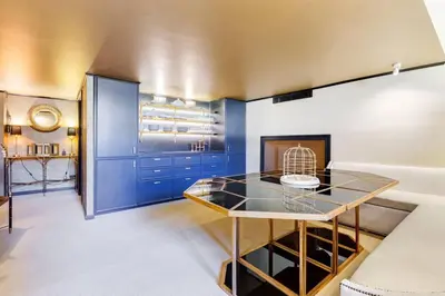 a dining room with blue cabinets and a glass table at Luxurious loft facing the Pantheon in Rome