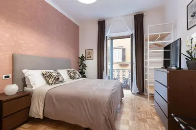 a bedroom with a bed with a television and a dresser at Urbana Apartment Colosseum in Rome
