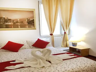 two swans are sitting on top of a bed at Myomax Guesthouse Hospety Group in Rome