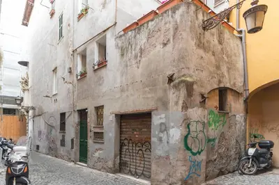 an old building with graffiti on it on a street at GuestHost - Campo De' Fiori Central Flat in Rome