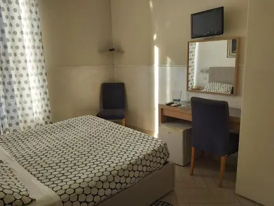a bedroom with a bed and a desk and a mirror at Bed & Breakfast Agli Horti Sallustiani in Rome