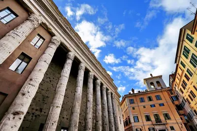 a building with columns and a clock tower in a city at Pantheon Stylish Attic in Rome