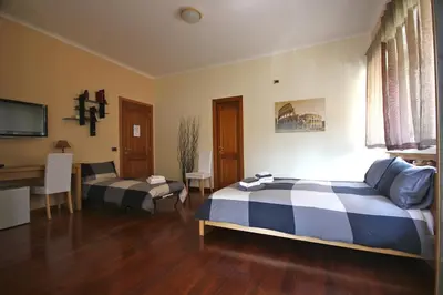 a bedroom with a bed and a desk in it at AnnoDomini in Rome