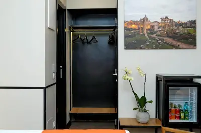a black door in a room with a refrigerator at Colonna 32 in Rome