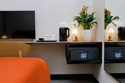 an office cubicle with an orange chair and a desk at Colonna 32 in Rome