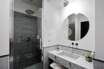 a bathroom with a sink and a mirror at Colonna 32 in Rome