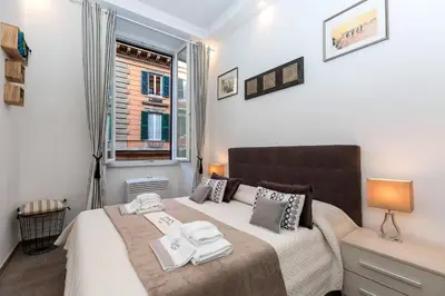 a bedroom with a bed with towels on it at Boutique Domus Trastevere Bertani in Rome